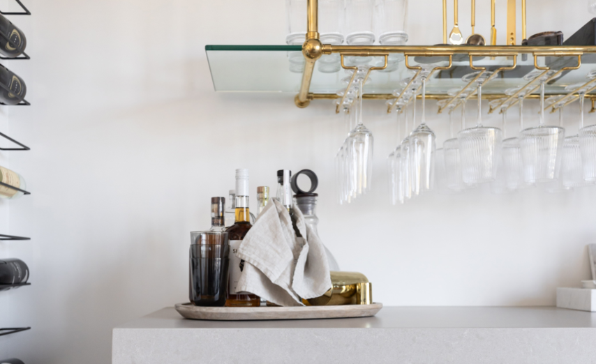 Stemware option shown on polished brass, ball style shelving, holding many rows of wine glasses