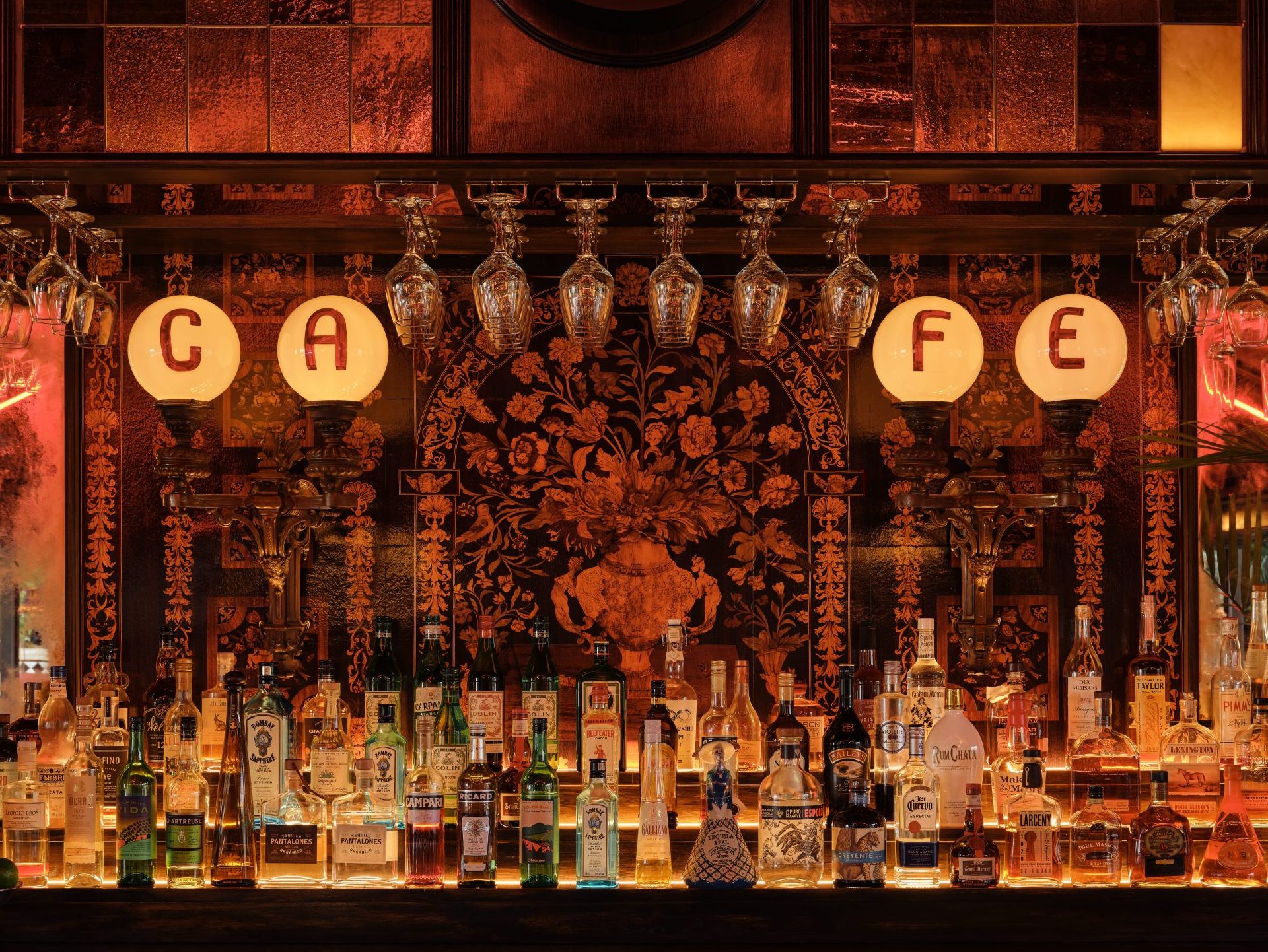 Stemware holders at El Royal bar. Mounted to wood shelving